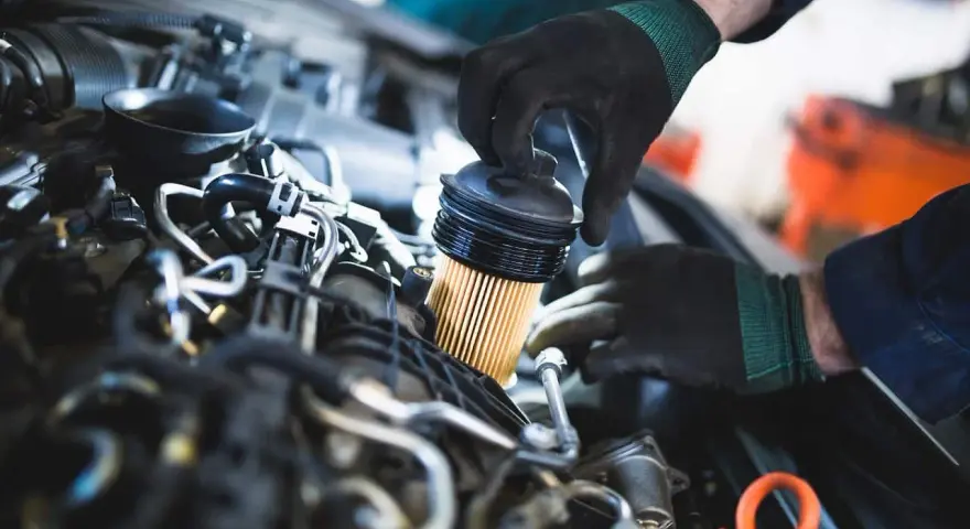 Mechanik wymienia filtr paliwa w silniku. Pamiętaj, co ile wymieniać filtr paliwa, by auto działało sprawnie.